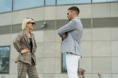 Two business people are thinking and talking about the company plans