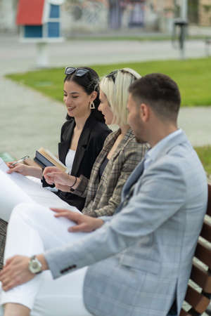 Three urban business people are thinking about the bluepritns for the companyの写真素材