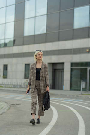 BUsinesswoman is looking at the company while thinking about the meetingの写真素材