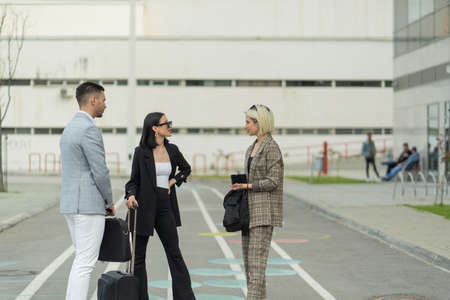 Three business people are talkking about the plans for the companyの写真素材