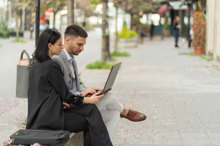 Two business people are looking at the laptopの写真素材