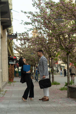 Two casual dressed business people are having a great time together on their breakの写真素材