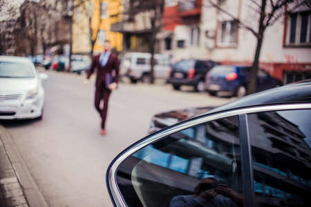 Blurred image of businessmen goes to his limousineの写真素材
