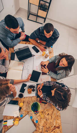 Professional young managers are sitting on the office table and making a plan