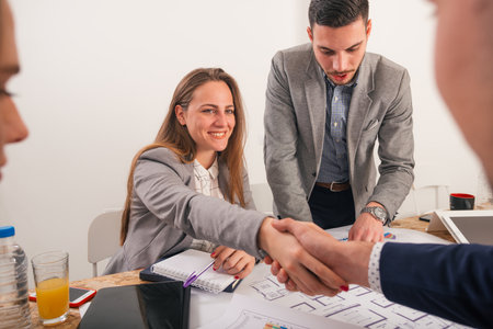Male and female business sitting on a business table looking formal while discussing their next...