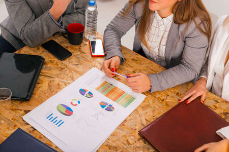 Young business people and entrepreneurs formally dressed at a business meeting.
