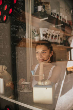 Coffee fun brunette, portrait of young beauty enjoying her beverageの写真素材