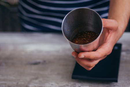 Young barista standing and show fresh coffee at coffee barの写真素材