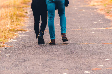 Boots and Jeans,couple walking in the park.の写真素材