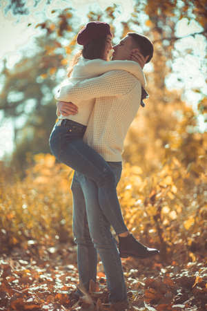 Couple in love kissing on a sunny day, they are wearing blue jeans and white blousesの写真素材