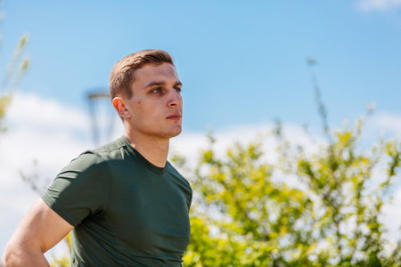 Sport man running. Portrait of runner man jogging in park. Sport workout outdoor. Athlete training run exerciseの写真素材