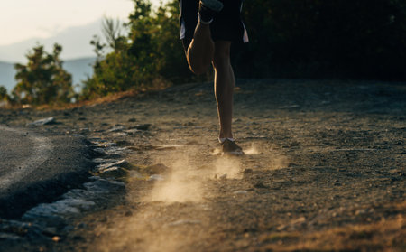 Close up runner feet. Man runner legs and shoes in action on road outdoors at road. Male athlete modelの写真素材
