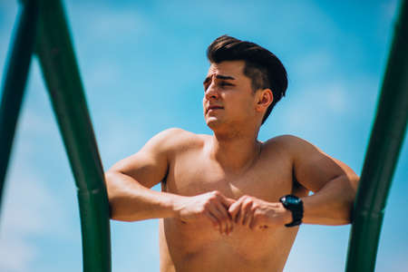 Young athlete doing stretching exercise, preparing for morning training. Fitness, sport, lifestyle conceptの写真素材