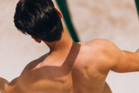 Portrait of a confident strong shirtless male bodybuilder preapiring for exercisingの写真素材