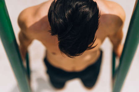 Parallel bar dips. strength power and workout. sport lifestyle. man exercising outdoorsの写真素材