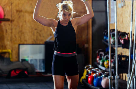 Strong girl is in the gym and doing exercise