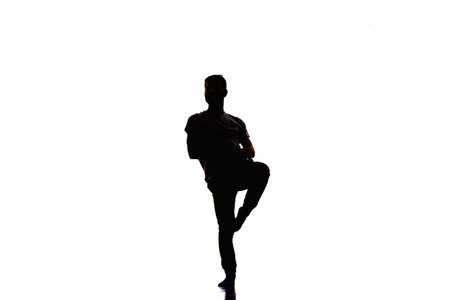 Handsome silhouette guy doing breakdance on white backgroundの写真素材
