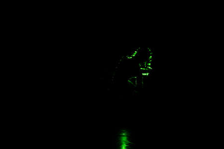 Modern dance moves performed by a dance artist illuminated with laser beamsの写真素材