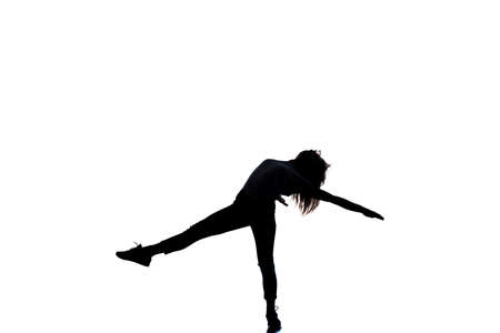 Girl is dancing in the studio on a white backgroundの写真素材