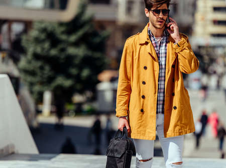 Urban businessman with stylish clothing walking in the cityの写真素材