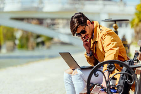 Man chilling out in city center while speak on mobile