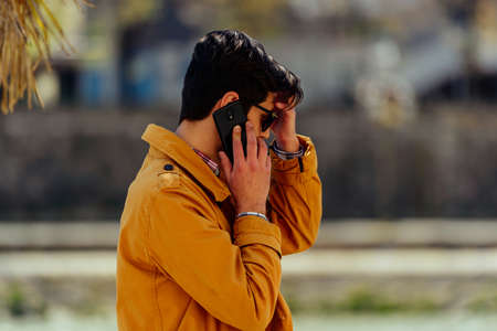 Attractive lawyer talking on cellphone during walking in the city centerの写真素材