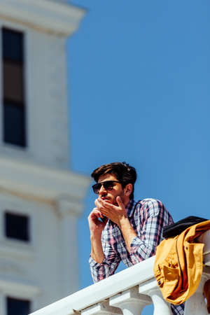 Casual businessman make call conversation while relaxing in sunny day