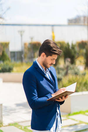 Businessman is writing his work plans about his company and business