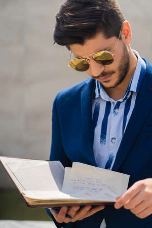 Handsome businessman is having a secod look about his own work