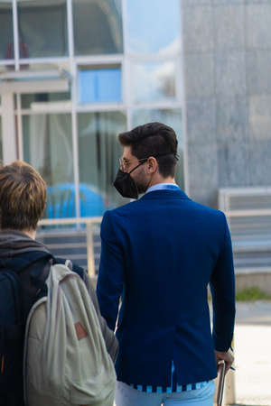 Urban businessman is talking with his assistent about the meeting he is heading to with his business...