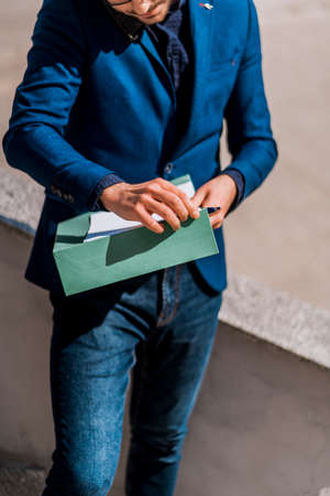 Fashion male businessman with cellphone going in his office
