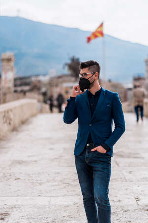 Fashion male businessman with cellphone going in his office