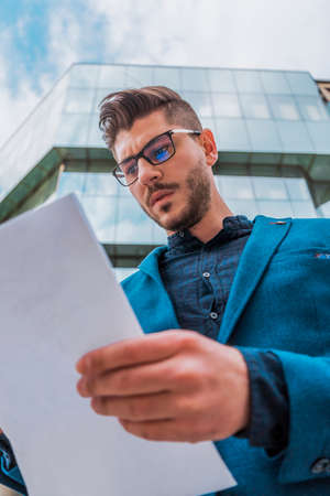 Closeup of businessman or lawyer signing an important contract, document or paperwork
