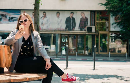 Beautiful woman browsing internet happy in her smart phoneの写真素材