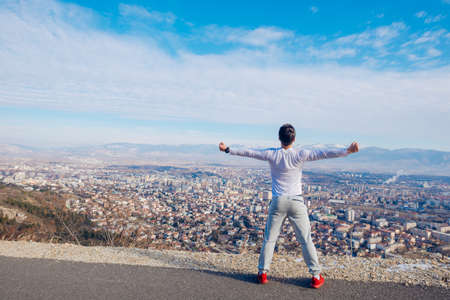 Fit male stretching and performing his morning routines while wearing a white shirt.の写真素材