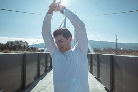 Full length portrait of sportsman while training on the bridge