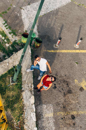 Showing view down from metal construction and seeing two people looking upの写真素材
