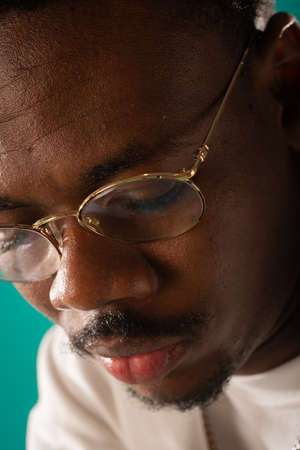 Close up portrait of attractive black male looking down