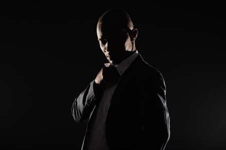 Portrait of formal suited black male psoing in studioの写真素材