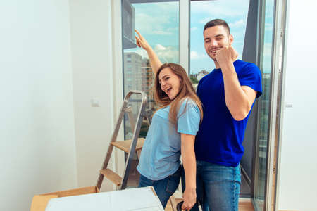 Portrait of cheerful couple embracing their new house