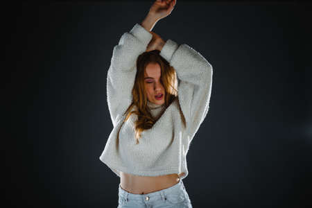 Fashion portrait of sexy beautiful blonde with great figure wearing jeans