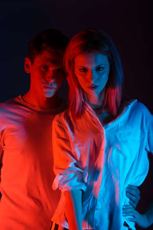 Sensual loving man and woman posing against a black backgroundの写真素材