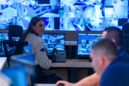 In the System Control Room, Technical Operator Works at His Workstation with Multiple Displays,...