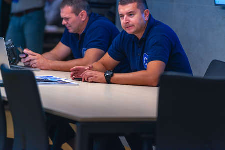 Group (security officers) tech guys meeting in a main security data center office.