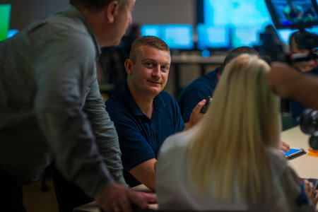 Security guard monitoring modern CCTV cameras in a surveillance room. Group of security guards...
