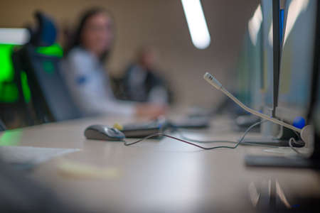 Security guard monitoring modern CCTV cameras in a surveillance room.の写真素材