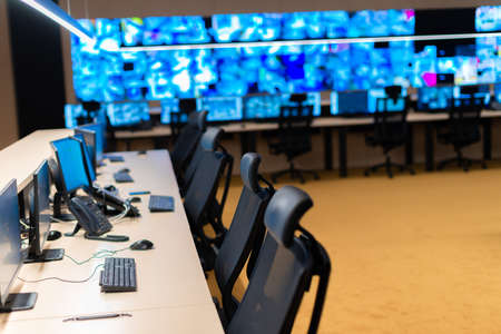 Empty office, desk, and chairs at a main CCTV security data center.の写真素材