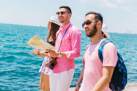 Tourists looking at a map and planning the places they are supposed to visit.の写真素材