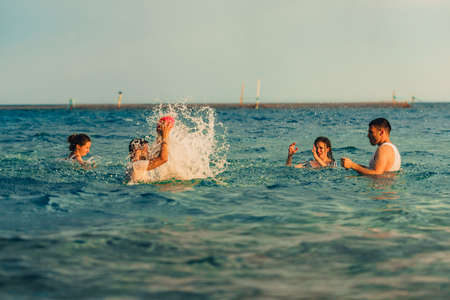 Group of tourists swimming in the sea in the turquoise water on summer vacationsの写真素材
