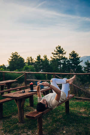 Portrait of a creative man architect or designer relaxing and lying outdoors at the forestの写真素材